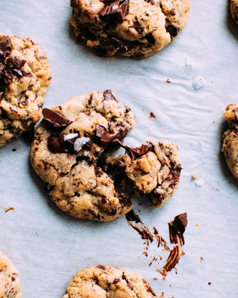 Chocolate chip cookies with melted chocolate on parchment